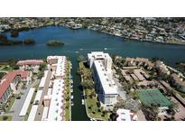 Stunning aerial view of waterfront condos with boat docks, lush landscaping, and serene water views at 1250 N Portofino Dr # 201, Sarasota, FL 34242