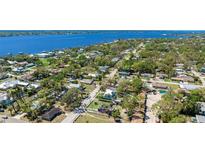 Stunning aerial view of a waterfront neighborhood featuring lush greenery and the home circled at 1406 5Th W St, Palmetto, FL 34221
