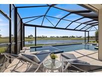Relax in this covered pool area overlooking a picturesque lake on a clear day at 3564 Santa Caterina Blvd, Lakewood Ranch, FL 34211