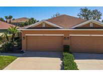 Charming home featuring a neatly manicured lawn and a two-car garage at 4015 Bridlecrest Ln, Bradenton, FL 34209