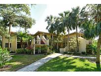 Beautiful exterior view of condos with mature landscaping and inviting walkway at 6450 Wild Oak Bay Blvd # 240, Bradenton, FL 34210