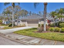 Charming single-story home with well-manicured lawn, mature landscaping, and a two-car garage at 6907 Stoneywalk Ct, Bradenton, FL 34203