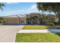 Charming single-story home with well-manicured lawn and a paver driveway leading to an attached two-car garage at 742 Shadow Bay Way, Osprey, FL 34229