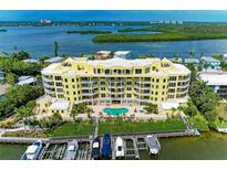 Beautiful waterfront condo building with boat docks and a refreshing pool overlooking scenic bay views at 9122 Midnight Pass Rd # 24, Sarasota, FL 34242