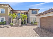 Inviting condo with lush landscaping, brick driveway, and convenient two-car garage at 12410 Osorio Ct # 204, Sarasota, FL 34238