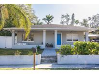 Charming home featuring a blue front door, a cozy front porch, and freshly landscaped yard at 1305 20Th W St, Bradenton, FL 34205