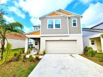 Inviting two-story home showcasing a modern design, two-car garage and well-maintained landscaping at 13068 Oak Hill Way, Parrish, FL 34219