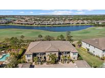 Stunning aerial view of residences along a golf course and lake community at 13711 Messina Loop # 101, Bradenton, FL 34211