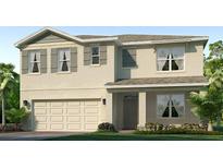 Charming two-story home featuring a two-car garage, neutral tones, and lush landscaping at 17218 Whiskey Creek Trl, Parrish, FL 34219