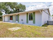 Charming single-story home featuring green shutters and a well-maintained lawn at 18348 Yale Ave, Port Charlotte, FL 33948