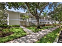 Charming two-story condo with mature trees, beautiful landscaping, and inviting walkways at 3702 54Th W Dr # 103, Bradenton, FL 34210