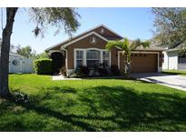 Charming single-story home with well-manicured lawn, lush landscaping, and a two-car garage at 6709 Rock Bridge Ln, Ellenton, FL 34222