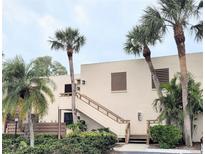 Inviting condo exterior with palm trees and a convenient staircase entrance to the units above the ground floor at 182 Pineneedle Dr # 182, Bradenton, FL 34210
