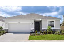 Charming single-story home with a two-car garage and beautifully landscaped front yard at 18224 Metado Dr, Lakewood Ranch, FL 34211