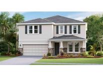 Charming two-story home featuring a stone veneer base, attached two car garage, and lush landscaping at 18320 Thistleberry Pl, Lakewood Ranch, FL 34211