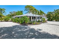 Charming single-story home features tropical landscaping and a crushed shell circular driveway at 2105 Hibiscus St, Sarasota, FL 34239