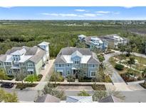 Stunning aerial view of a multi-story home with lush landscaping and a glimpse of the beautiful surroundings at 315 Sapphire Lake Dr # 202, Bradenton, FL 34209