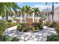Beautiful condominium exterior with lush landscaping, fountain, and private balconies on both floors at 4208 Central Sarasota Pkwy # 1422, Sarasota, FL 34238