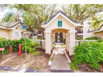 Inviting entrance to the building featuring well-maintained landscaping and classic architectural details at 5168 Northridge Rd # 209, Sarasota, FL 34238