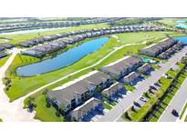 Stunning aerial view of homes surrounding a beautiful golf course and scenic ponds in a well-maintained community at 5685 Palmer Cir # 202, Bradenton, FL 34211