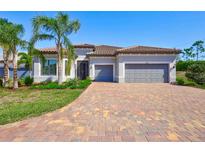 Beautiful single-Gathering home features a tile roof, well-manicured landscaping, and a brick driveway at 18115 Littleton Pl, Bradenton, FL 34202