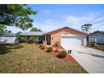 Charming single-story home with a well-manicured lawn and a two-car garage at 3502 18Th Avenue W Dr, Bradenton, FL 34205