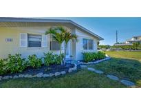 Charming single-story home featuring a well-maintained front yard and inviting entrance at 401 63Rd St, Holmes Beach, FL 34217