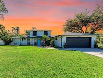 Charming two-story home with a well-manicured lawn and attached two car garage at 4283 Southwell Way, Sarasota, FL 34241