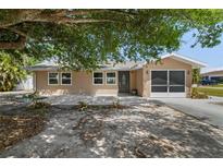 Charming single-story home featuring a screened in garage, and a well-maintained landscaped yard at 510 Marlin Dr, Punta Gorda, FL 33950
