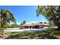 Spacious ranch home features a tile roof, attached garage, and paved circular driveway at 5714 38Th E Ave, Bradenton, FL 34208