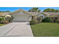 Charming one-story home with well-maintained landscaping and a two-car garage on a sunny day at 6017 Marella Dr, Sarasota, FL 34243