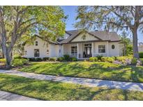 Beautiful exterior showcasing lush landscaping, a manicured lawn, and a charming facade at 6540 The Masters Ave, Lakewood Ranch, FL 34202