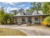 Charming home featuring a metal roof, solar panels, welcoming porch, and well-manicured landscaping at 6838 Rabbit Ave, North Port, FL 34291