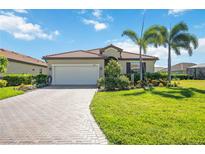 Charming single-story home featuring a tile roof, paved driveway, well-manicured lawn and beautiful landscaping at 10008 Carnoustie Pl, Bradenton, FL 34211