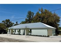 Beautifully landscaped home with a modern metal roof and well-maintained exterior at 3525 Mcintosh Rd, Sarasota, FL 34232