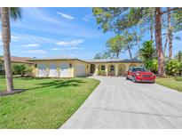 Charming single-story home with a well-manicured lawn and a long driveway, perfect for suburban living at 4320 Bent Tree Blvd, Sarasota, FL 34241