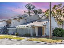 Charming townhome featuring a quaint patio and neutral exterior paint at 5753 Summer Side Ln # 8A, Sarasota, FL 34231