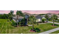 Beautiful single-story home with lush landscaping, tile roof, and a well-manicured lawn at 604 166Th E St, Bradenton, FL 34212