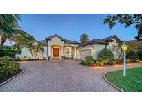 Beautiful home featuring a brick driveway, well-manicured landscaping and an attached two-car garage at 7340 Barclay Ct, University Park, FL 34201