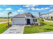 Beautiful single Gathering home with landscaped front yard, brick driveway, and attached two-car garage at 10006 Degas Ter, Bradenton, FL 34212