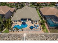 Aerial shot of beautiful backyard with a pool, patio, and direct water access at 1009 3Rd E St, Palmetto, FL 34221