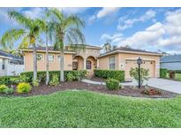 Charming single-Gathering home features a well-manicured lawn, mature landscaping, and a welcoming entrance at 11835 Hollyhock Dr, Lakewood Ranch, FL 34202