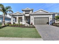 Beautiful single-story home with manicured lawn, lovely landscaping, paver driveway, and a two-car garage at 17907 Palmiste Dr, Bradenton, FL 34202
