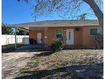 Charming single-story home with a covered carport and partially shaded front yard at 1804 Bayshore Gardens Pkwy, Bradenton, FL 34207