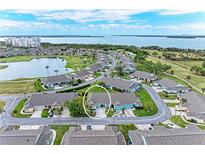 Waterfront community home with lush landscaping, lake, and golf course access with water views in the background at 3009 Live Oak Ln # 33, Palmetto, FL 34221