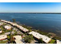 Stunning aerial view of waterfront condos with breathtaking water views on a sunny day at 3875 Catalina Dr, Bradenton, FL 34210