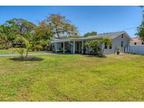 Charming single Gathering home featuring a well-maintained lawn and a covered driveway at 436 Parkview Dr, Sarasota, FL 34243