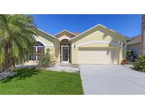 Charming single-story home with a well-manicured lawn and a two-car garage at 5806 New Paris Way, Ellenton, FL 34222