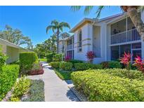 Inviting two-story condo featuring lush landscaping and a well-maintained walkway, perfect for enjoying the Florida sunshine at 6912 Drewrys Blf # 608, Bradenton, FL 34203