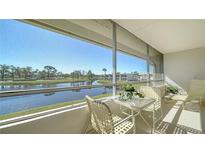 Enjoy the view from this screened balcony with table and chairs overlooking the water at 7231 W Country Club N Dr # 231, Sarasota, FL 34243